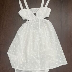 White mini dress with open back and sides